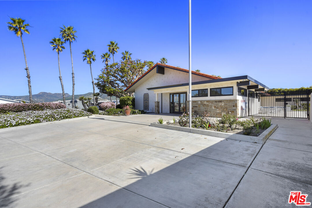 29500 Heathercliff Road, Unit 220 Malibu, CA 90265 - Photo 37 of 43 a front view of a house with a yard and a garage