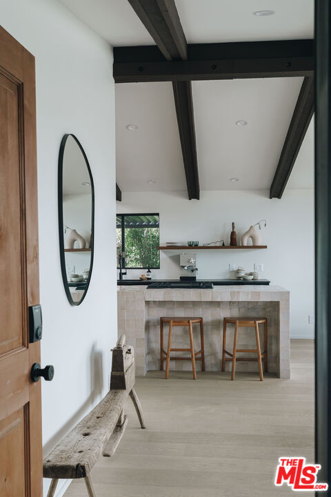 29500 Heathercliff Road, Unit 220 Malibu, CA 90265 - Photo 5 of 43 a living room with furniture a mirror and a clock