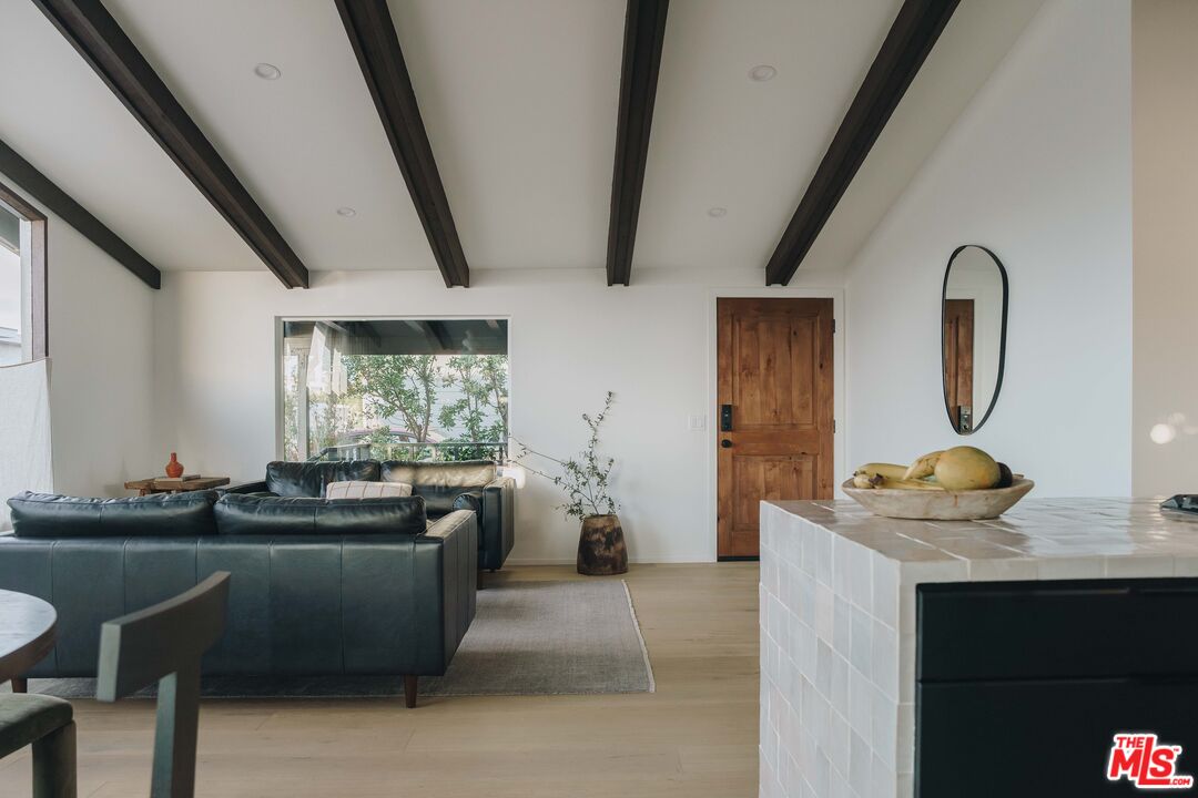 29500 Heathercliff Road, Unit 220 Malibu, CA 90265 - Photo 7 of 43 a living room with furniture and a mirror