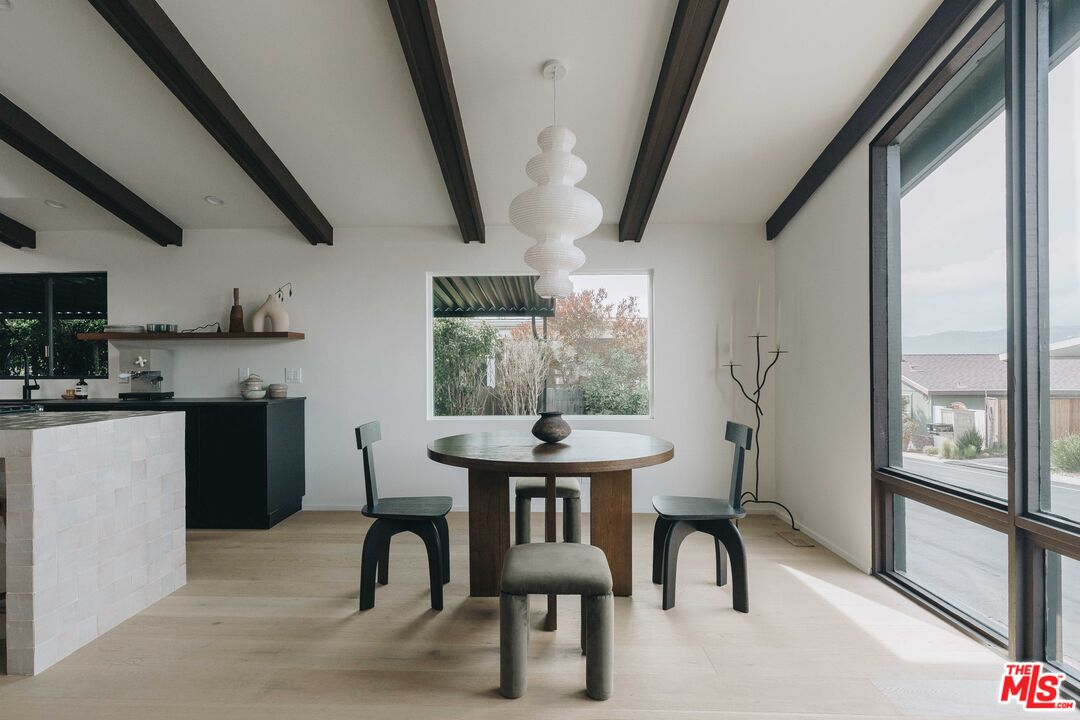 29500 Heathercliff Road, Unit 220 Malibu, CA 90265 - Photo 9 of 43 a dining room with furniture and window