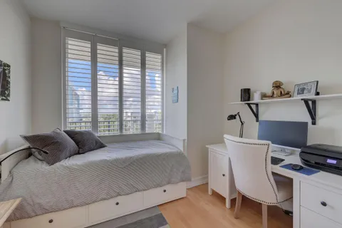 a bedroom with a bed and a desk