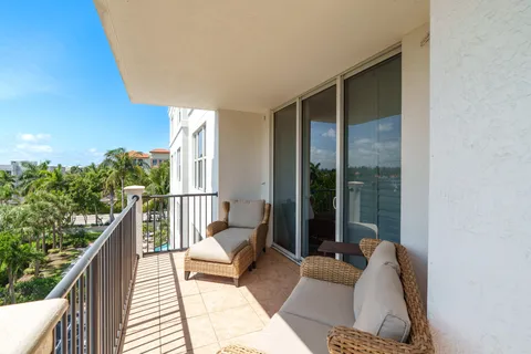a balcony with furniture and a potted plant