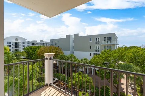 a view of a balcony with yard