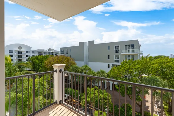 a view of a balcony with yard