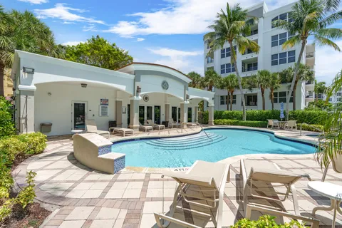 a view of a house with swimming pool and sitting area
