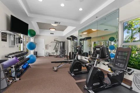 a room with gym equipment and a large window