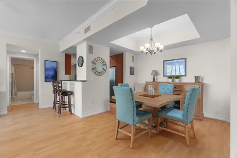 a view of a dining room with furniture and chandelier