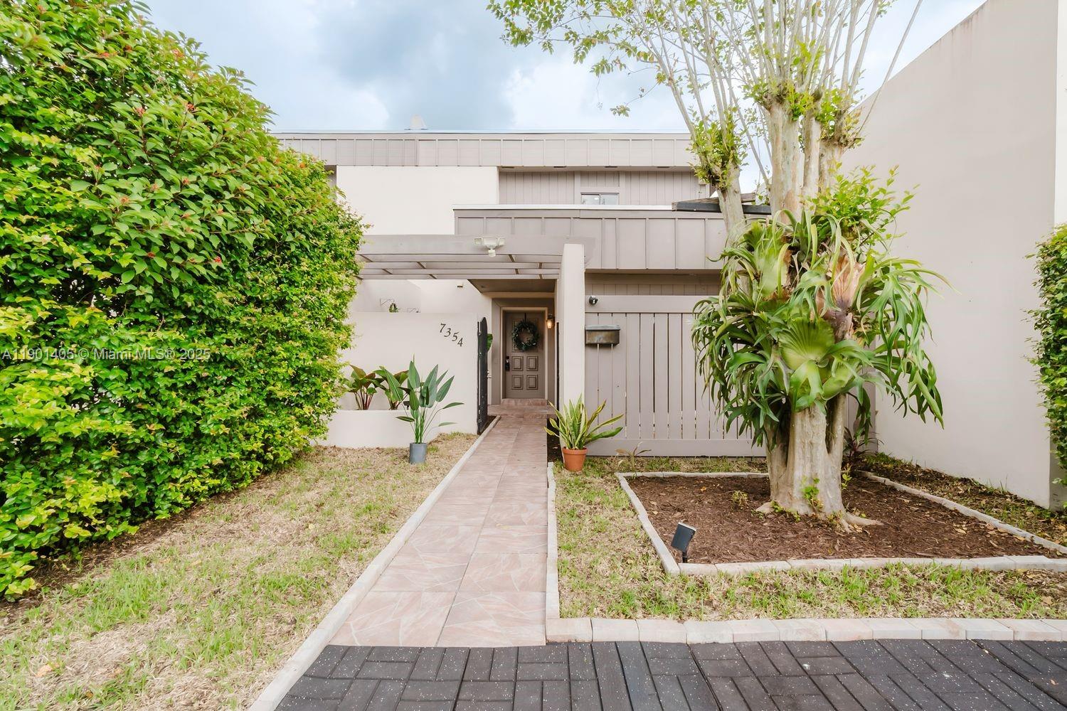 7354 Southwest 105th Place Miami, FL 33173 - Photo 3 of 15 a front view of a house with garden
