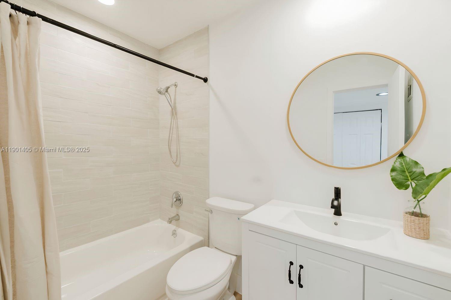 7354 Southwest 105th Place Miami, FL 33173 - Photo 4 of 15 a bathroom with a sink a toilet and a mirror