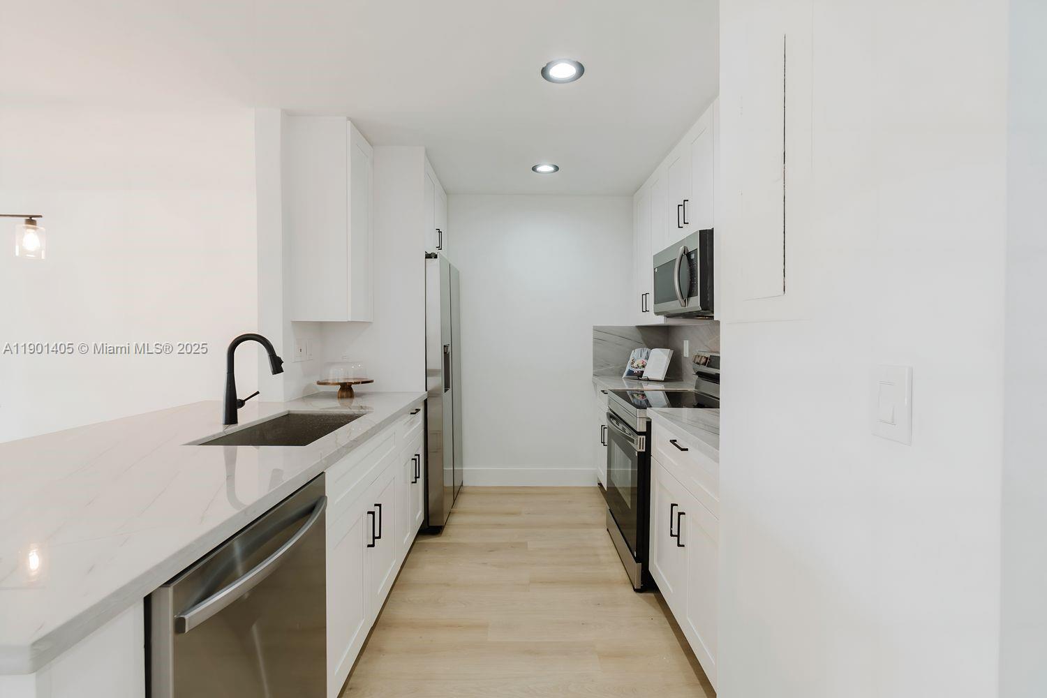 7354 Southwest 105th Place Miami, FL 33173 - Photo 6 of 15 a kitchen with stainless steel appliances granite countertop a sink and a stove top oven with dishwasher