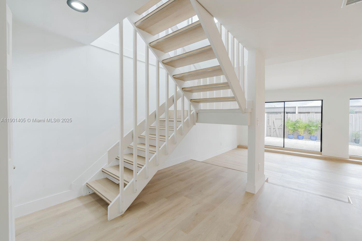 7354 Southwest 105th Place Miami, FL 33173 - Photo 7 of 15 an entryway with staircase and white walls