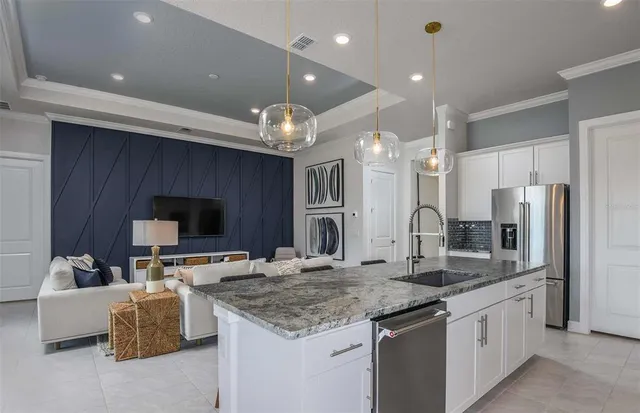 a kitchen with stainless steel appliances kitchen island granite countertop a stove and a sink