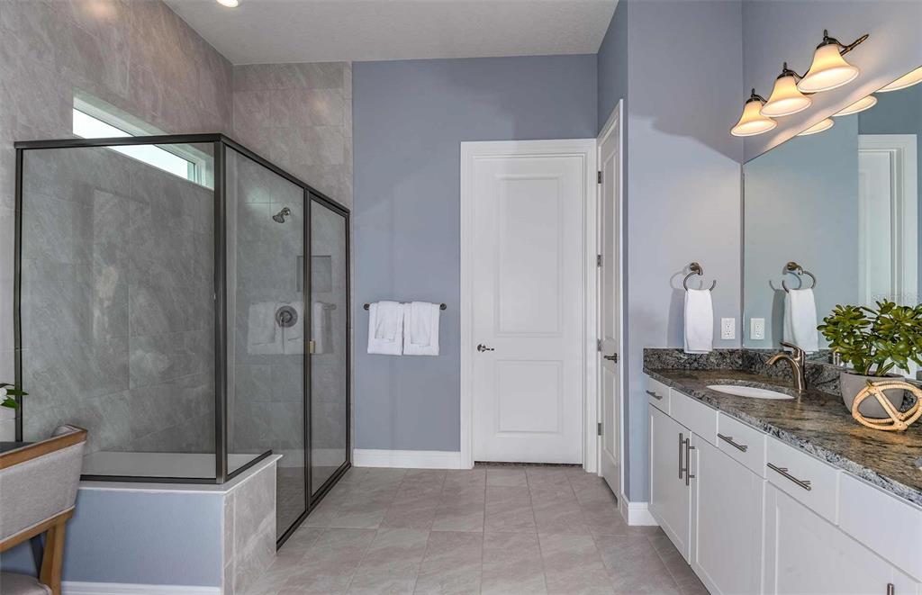 8372 Southwest 58 Loop Ocala, FL 34481 - Photo 7 of 30 a spacious bathroom with a granite countertop sink a mirror and shower