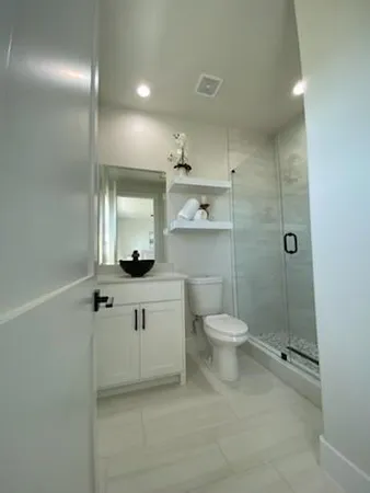a bathroom with a toilet sink and shower
