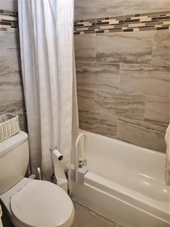 a bathroom with a toilet and a bathtub