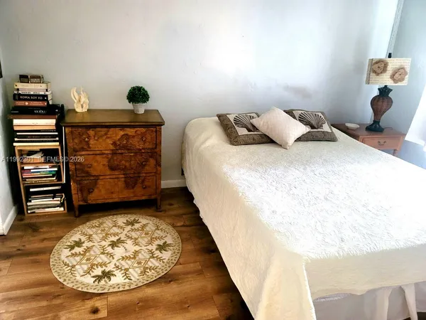 a bed room with a bed and a mirror