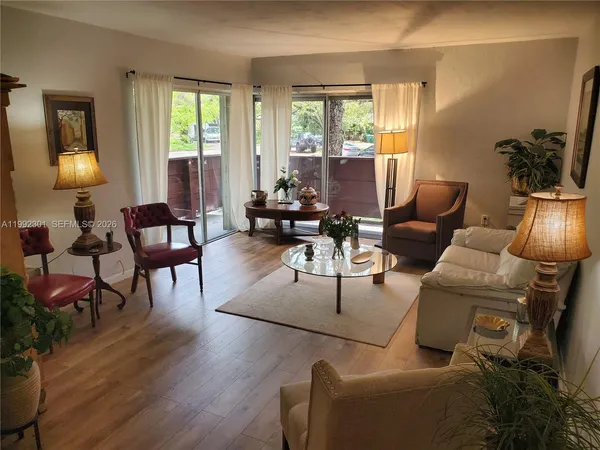 a living room with furniture and a lamp