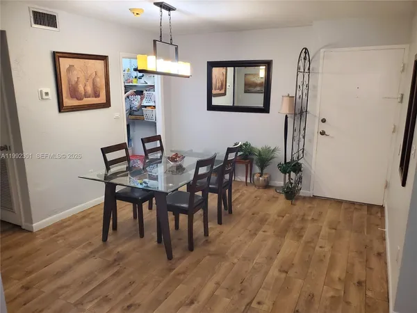a view of a dining room with furniture and wooden floor