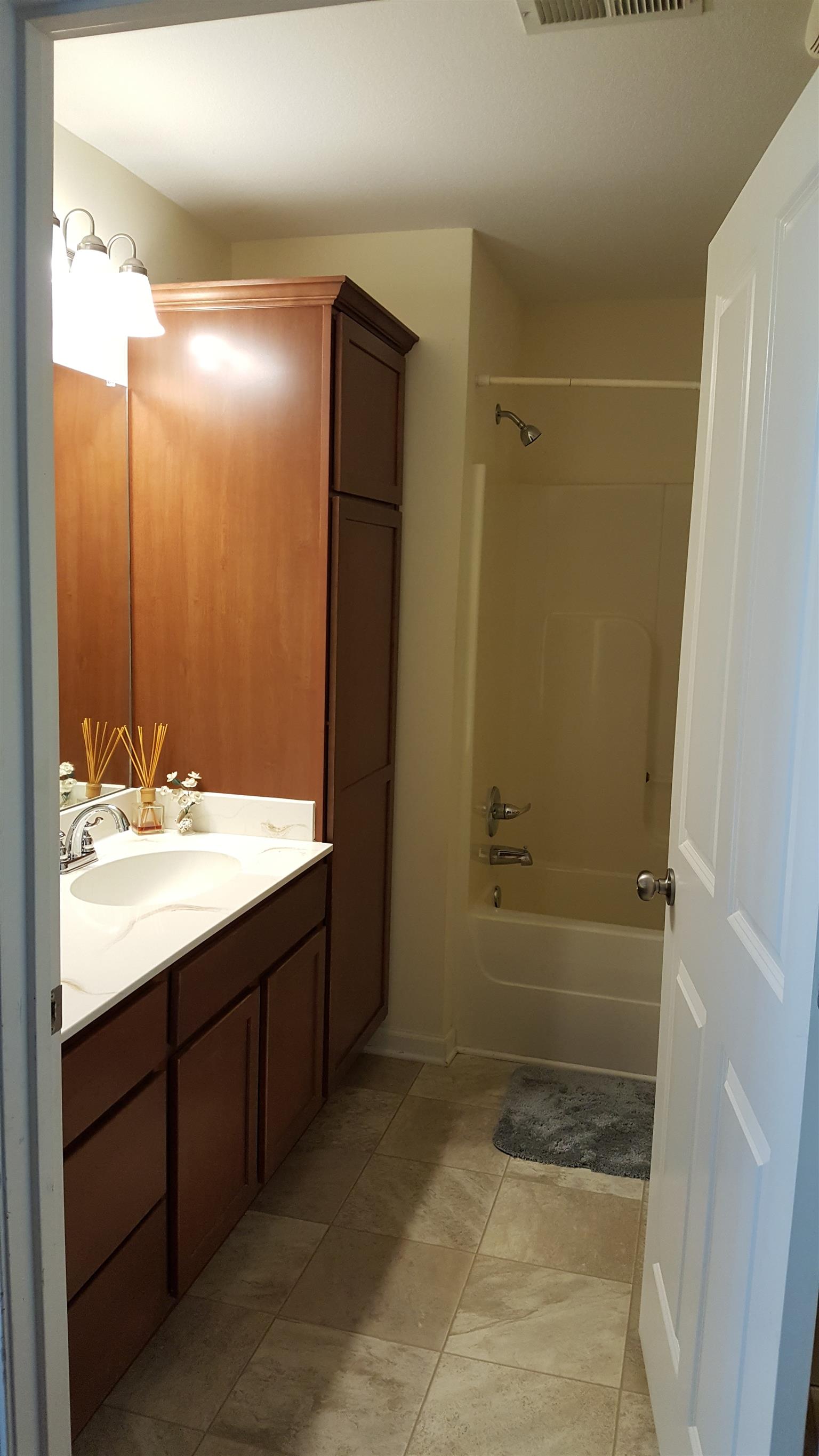 2960 Rossview Road Clarksville, TN 37043 - Photo 4 of 26 a bathroom with a granite countertop sink shower and a mirror