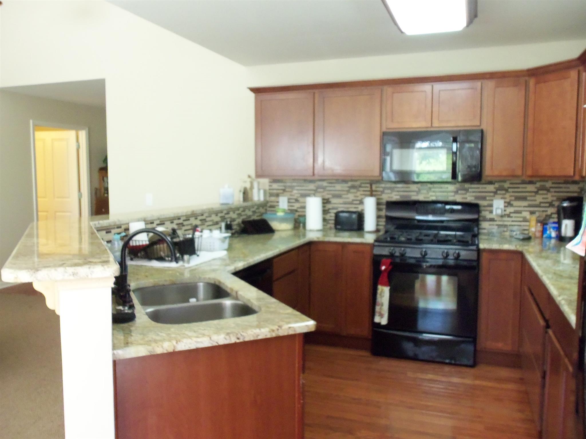 2960 Rossview Road Clarksville, TN 37043 - Photo 8 of 26 a kitchen with stainless steel appliances granite countertop a sink stove and refrigerator