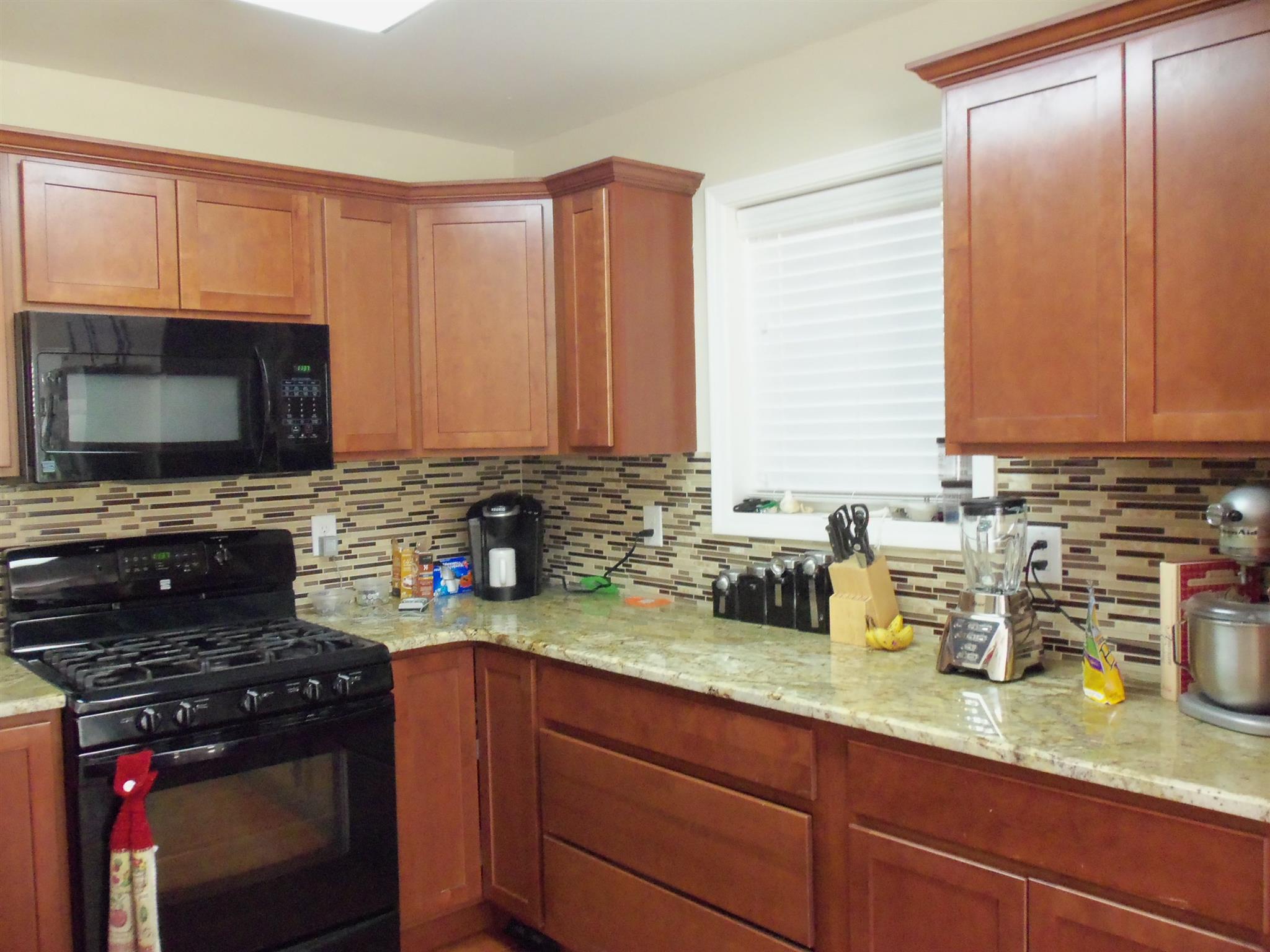 2960 Rossview Road Clarksville, TN 37043 - Photo 9 of 26 a kitchen with a sink a stove and cabinets