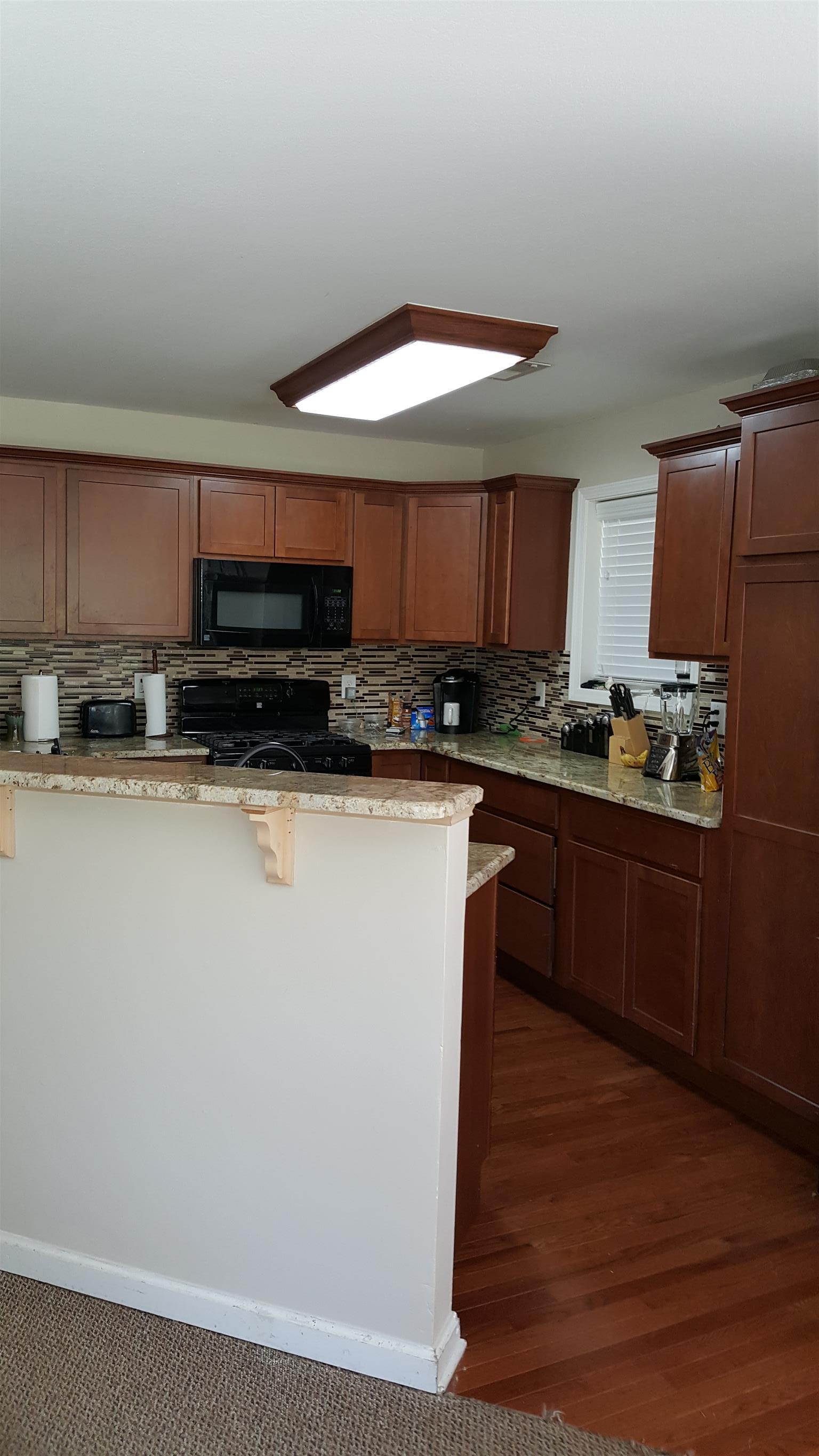 2960 Rossview Road Clarksville, TN 37043 - Photo 10 of 26 a kitchen with stainless steel appliances granite countertop a stove a sink and a microwave