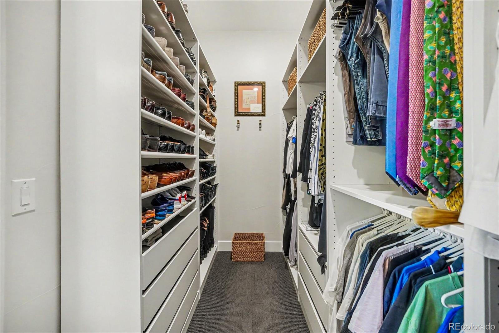 2101 Rim Ridge Drive Castle Pines, CO 80108 - Photo 24 of 50 a view of walk in closet with clothes and shoes