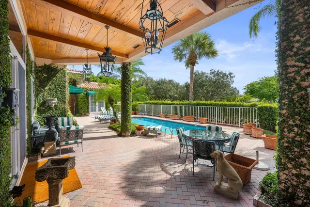 a view of a patio with a table chairs and a potted plant
