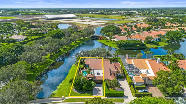 an aerial view of residential houses with outdoor space and lake view