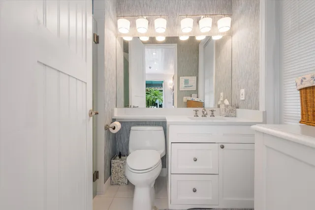 a bathroom with a sink a mirror and a toilet