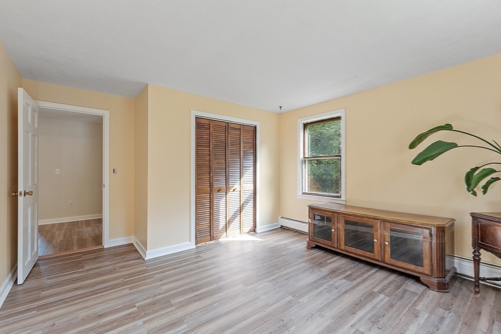 215 Colburn Road Temple, NH 03084 - Photo 23 of 40 an empty room with wooden floor and windows