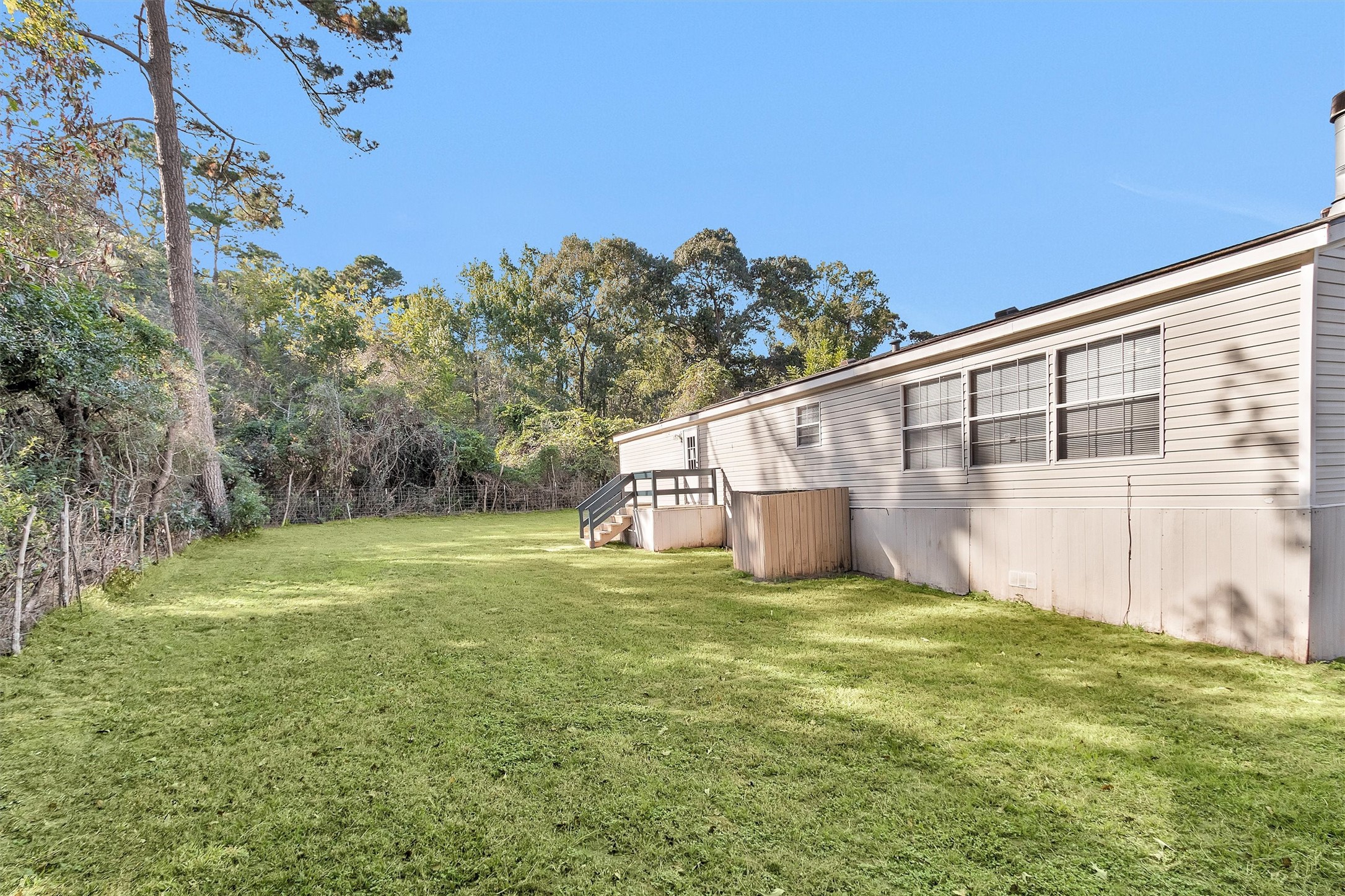 11261 Rose Road Conroe, TX 77303 - Photo 27 of 30 a view of a back yard of the house