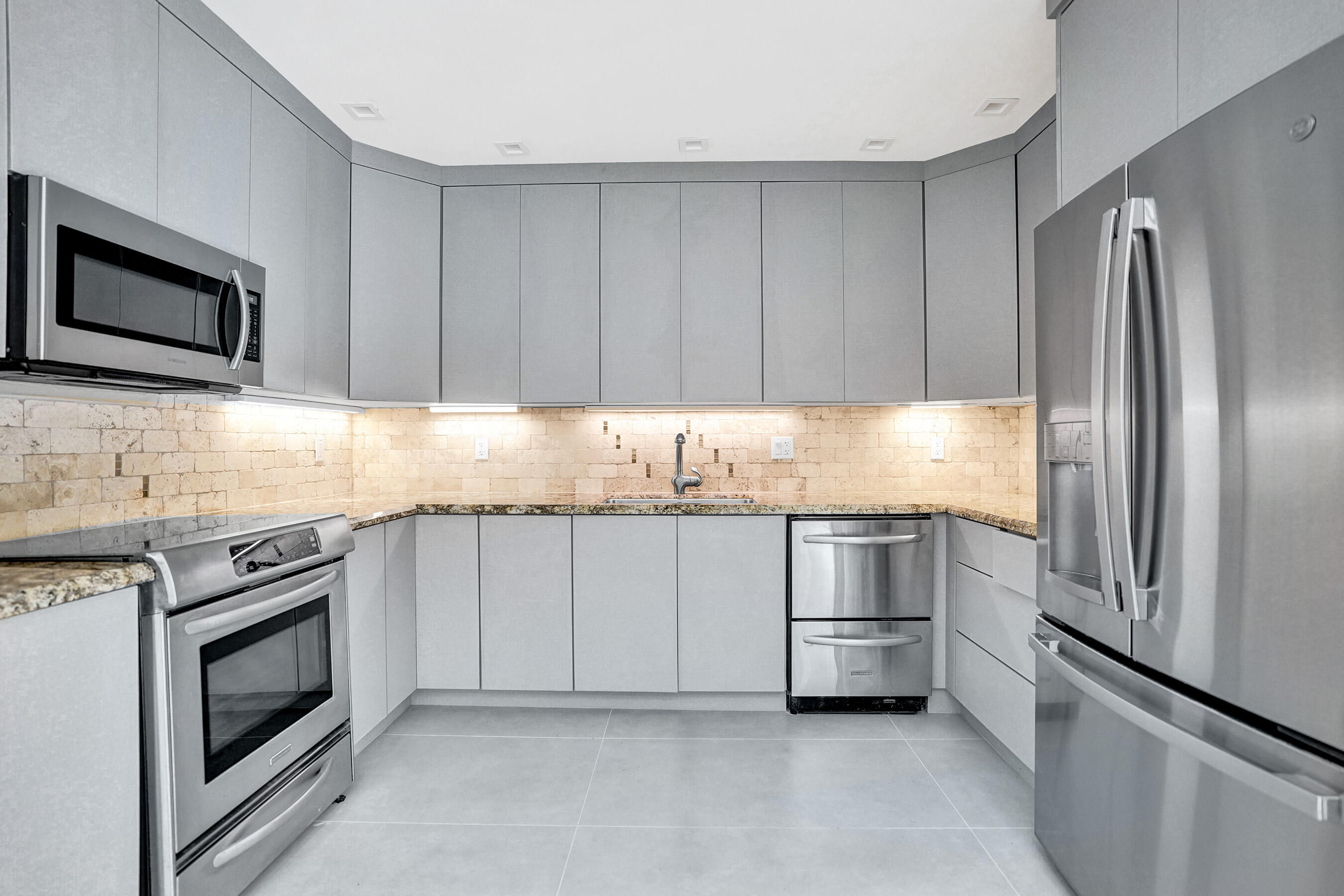 3779 Northwest 4th Court Boca Raton, FL 33431 - Photo 12 of 20 a kitchen with granite countertop stainless steel appliances and white cabinets