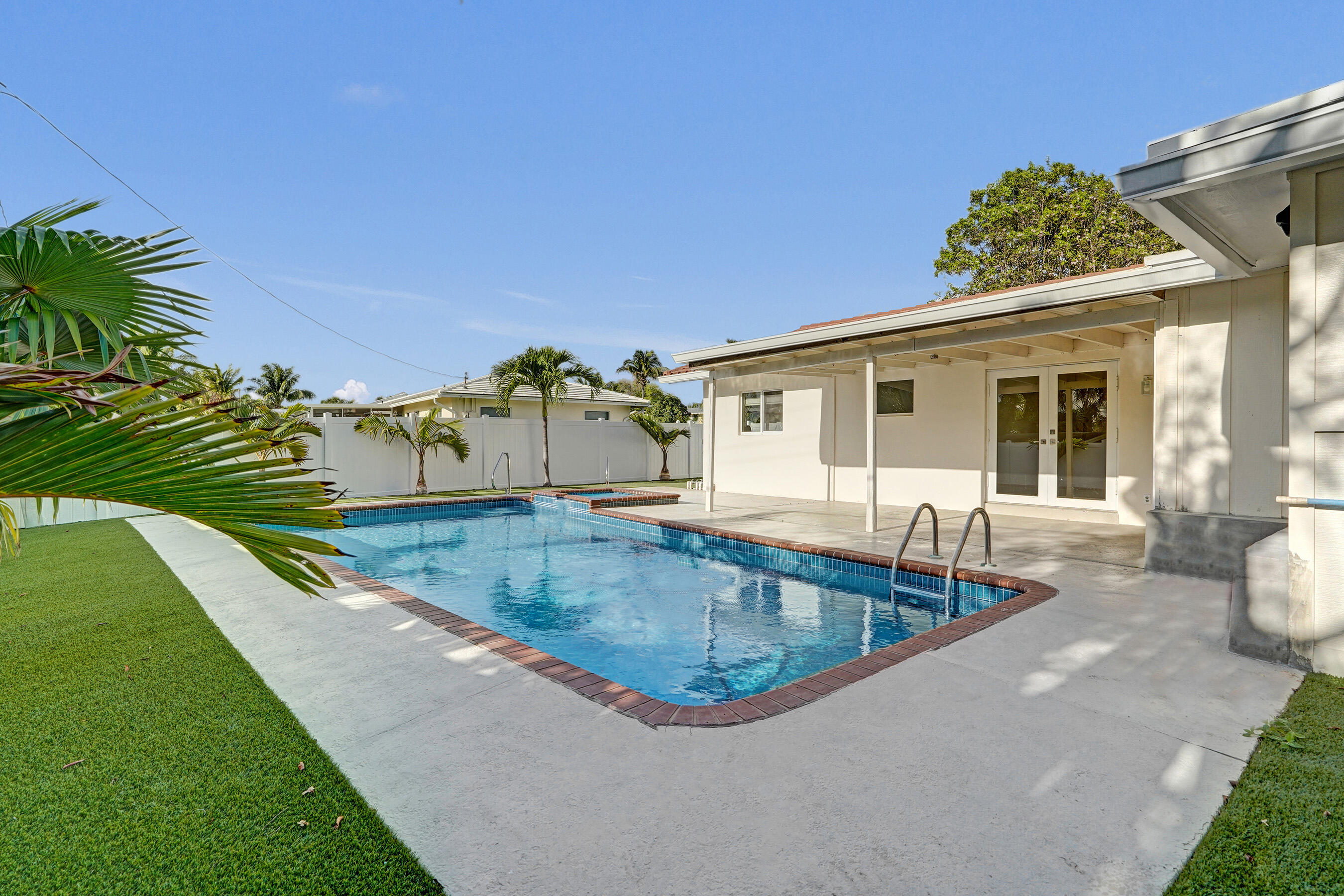 3779 Northwest 4th Court Boca Raton, FL 33431 - Photo 5 of 20 a view of a house with swimming pool and sitting area