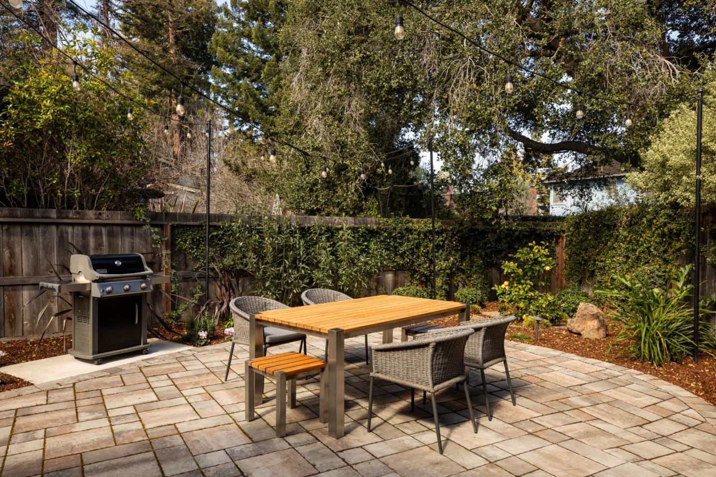 135 Emma Lane Menlo Park, CA 94025 - Photo 15 of 16 a backyard of a house with table and chairs