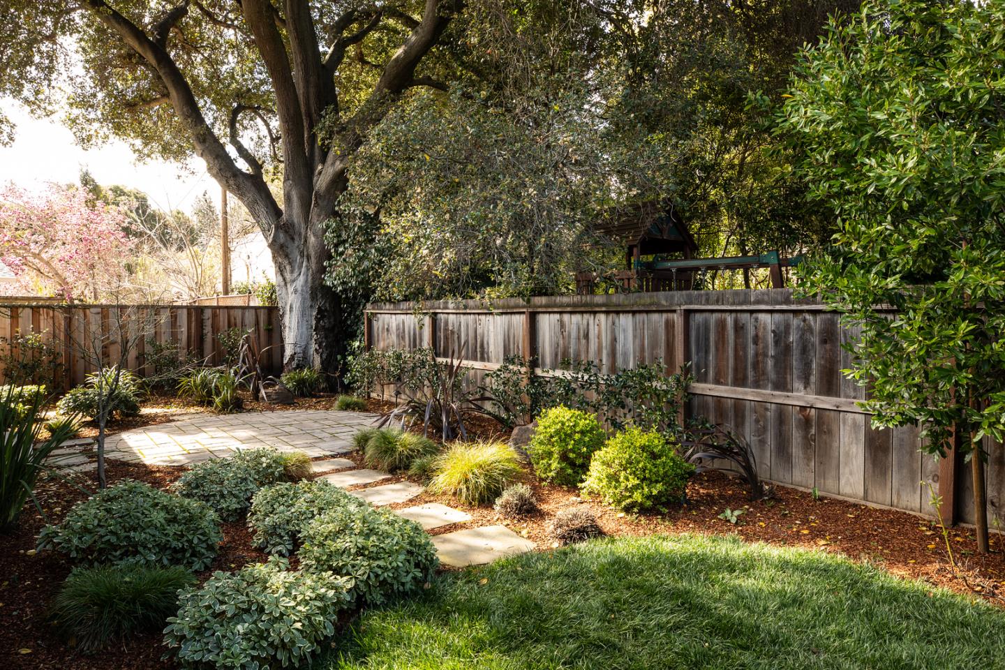 135 Emma Lane Menlo Park, CA 94025 - Photo 16 of 16 a view of a backyard with a garden