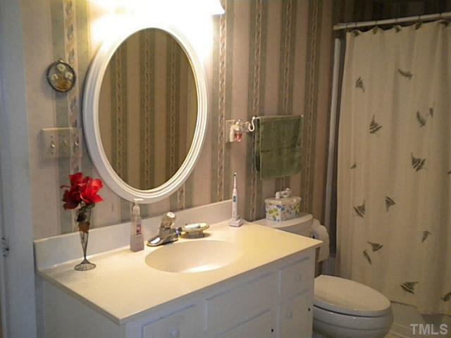 1024 Pagan Road Raleigh, NC 27603 - Photo 14 of 25 a bathroom with a sink a toilet and shower