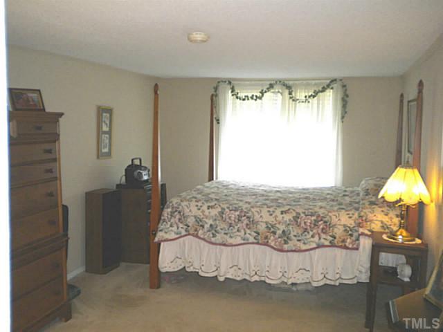 1024 Pagan Road Raleigh, NC 27603 - Photo 15 of 25 a bedroom with a bed and a lamp