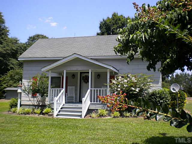 1024 Pagan Road Raleigh, NC 27603 - Photo 17 of 25 a front view of a house with a yard and potted plants