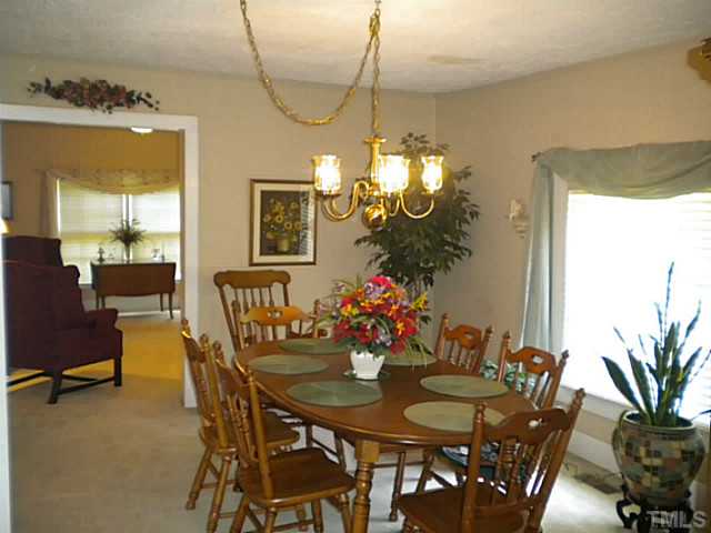 1024 Pagan Road Raleigh, NC 27603 - Photo 7 of 25 a view of a dining room with furniture and a chandelier