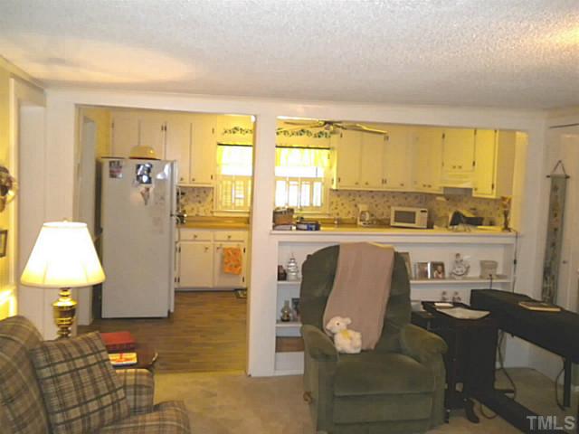 1024 Pagan Road Raleigh, NC 27603 - Photo 10 of 25 a living room with kitchen island furniture and a window