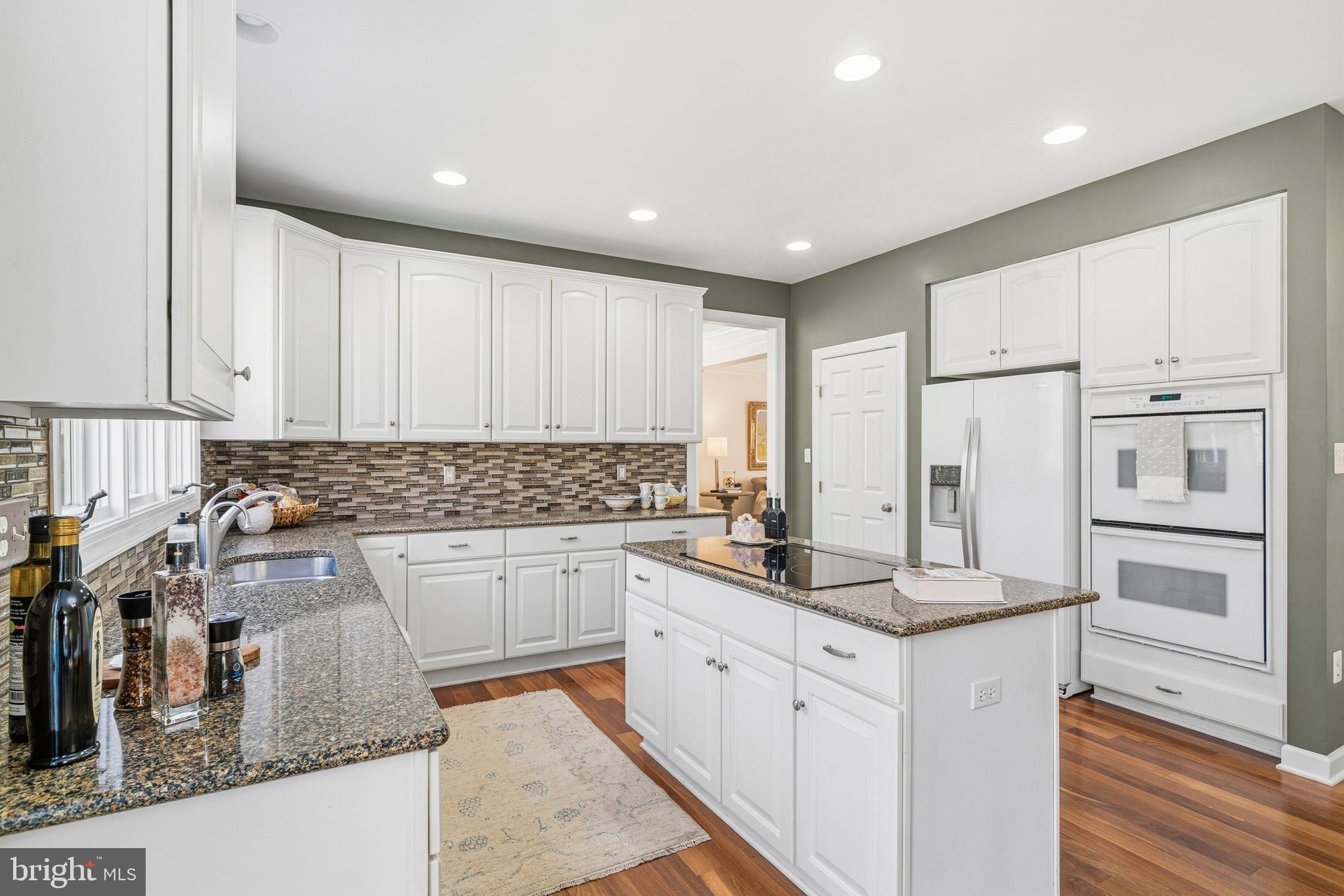 18700 Olney Mill Road Olney, MD 20832 - Photo 17 of 86 a kitchen with stainless steel appliances granite countertop a stove and white cabinets