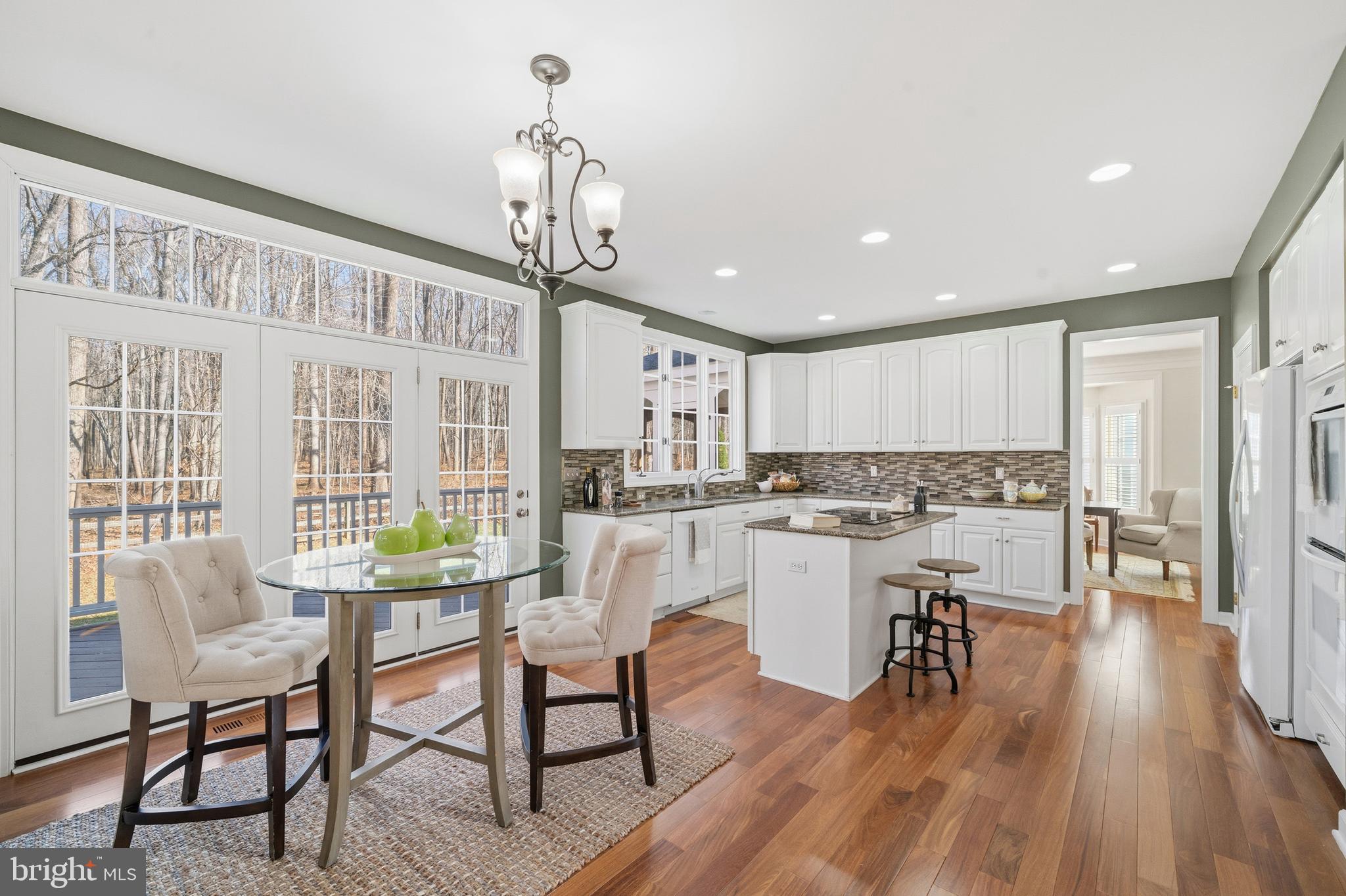 18700 Olney Mill Road Olney, MD 20832 - Photo 21 of 86 a kitchen with a table chairs wooden floors and a view of living room