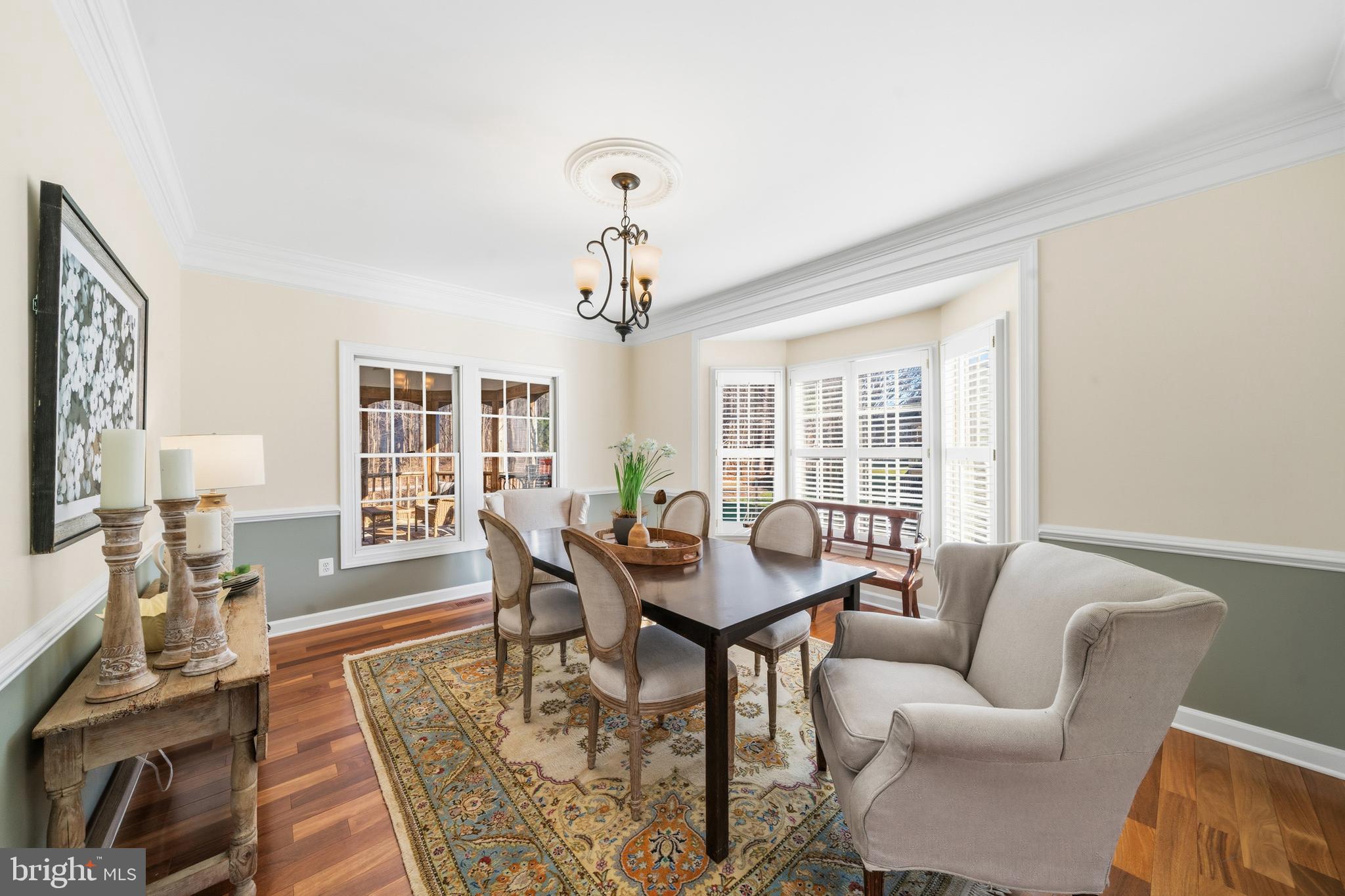 18700 Olney Mill Road Olney, MD 20832 - Photo 33 of 86 a dining room with furniture a rug and a chandelier
