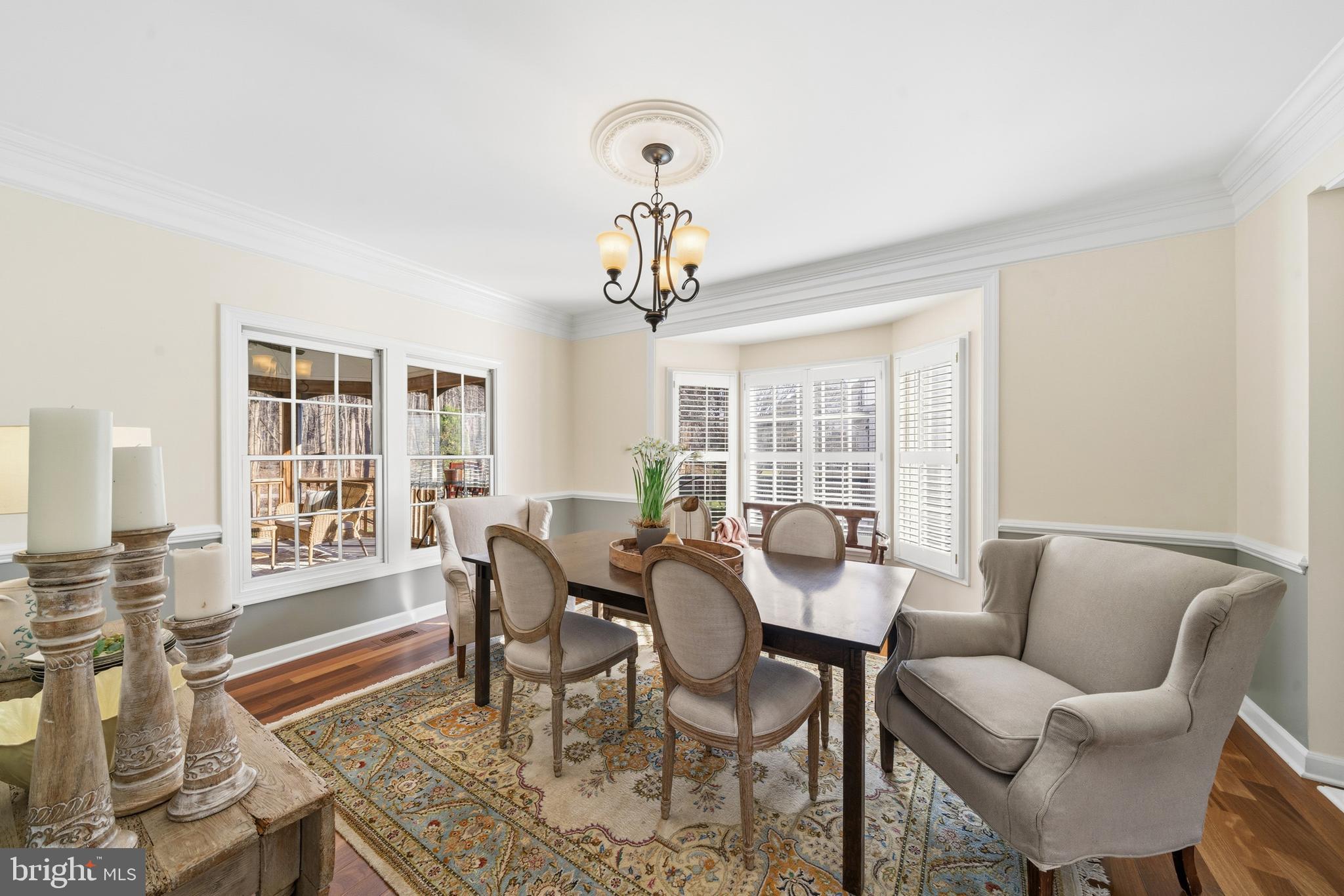 18700 Olney Mill Road Olney, MD 20832 - Photo 36 of 86 a dining room with furniture a chandelier and wooden floor