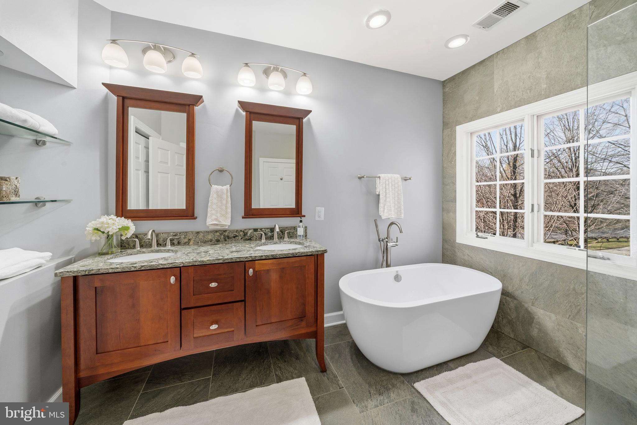 18700 Olney Mill Road Olney, MD 20832 - Photo 47 of 86 a bathroom with a white tub sink and mirror