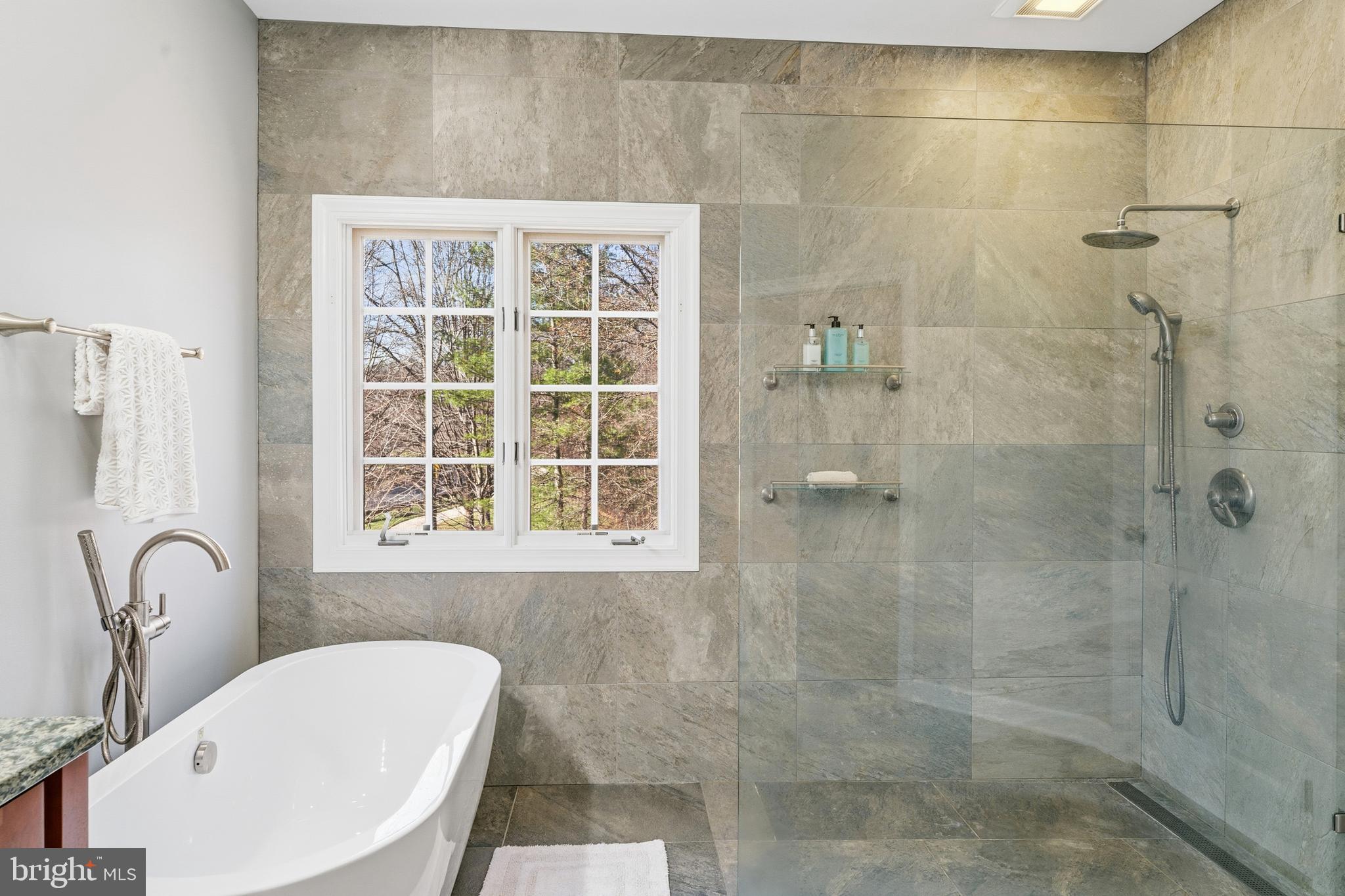 18700 Olney Mill Road Olney, MD 20832 - Photo 48 of 86 a bathroom with a granite countertop bathtub shower and a sink