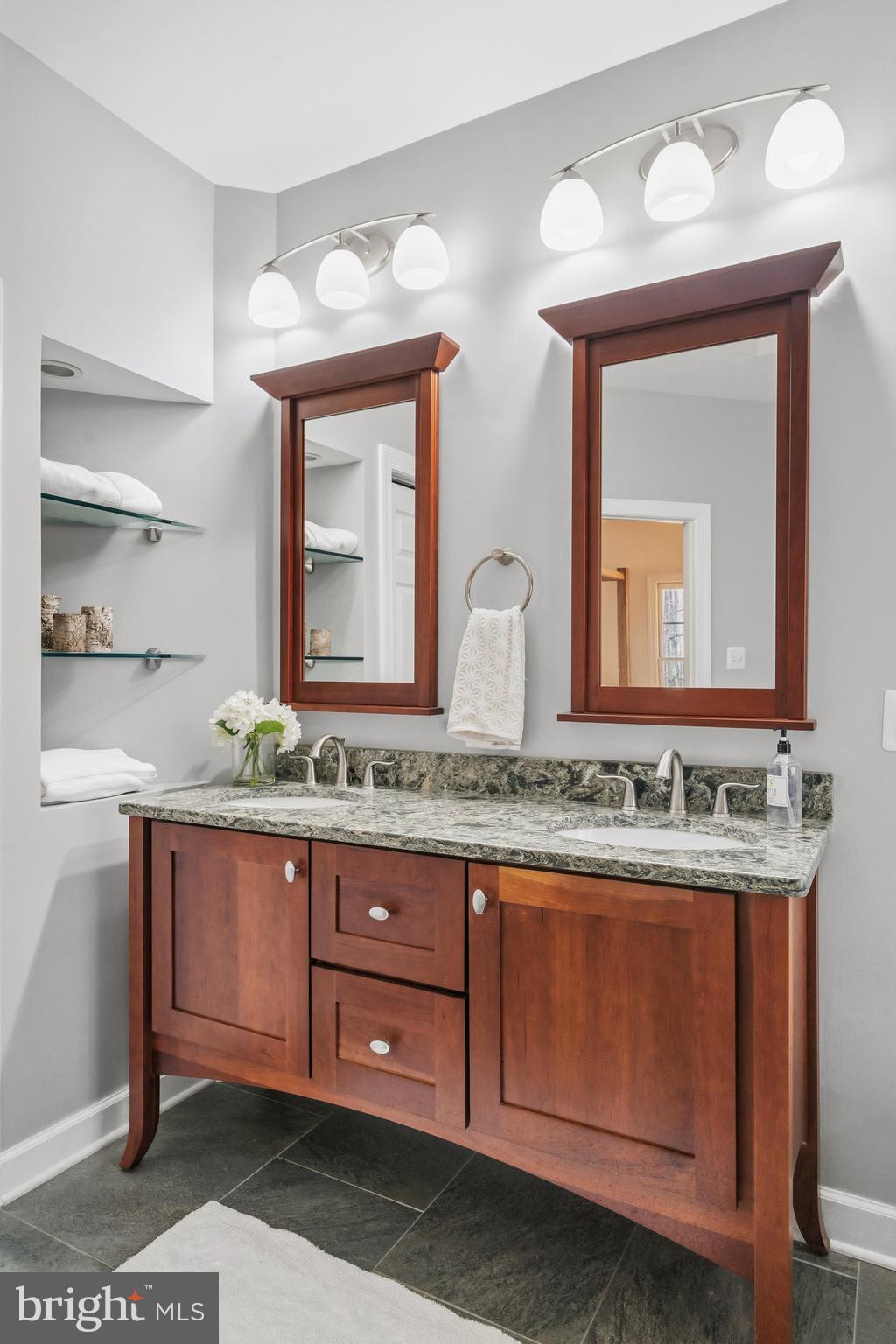 18700 Olney Mill Road Olney, MD 20832 - Photo 50 of 86 a bathroom with a granite countertop sink and a mirror