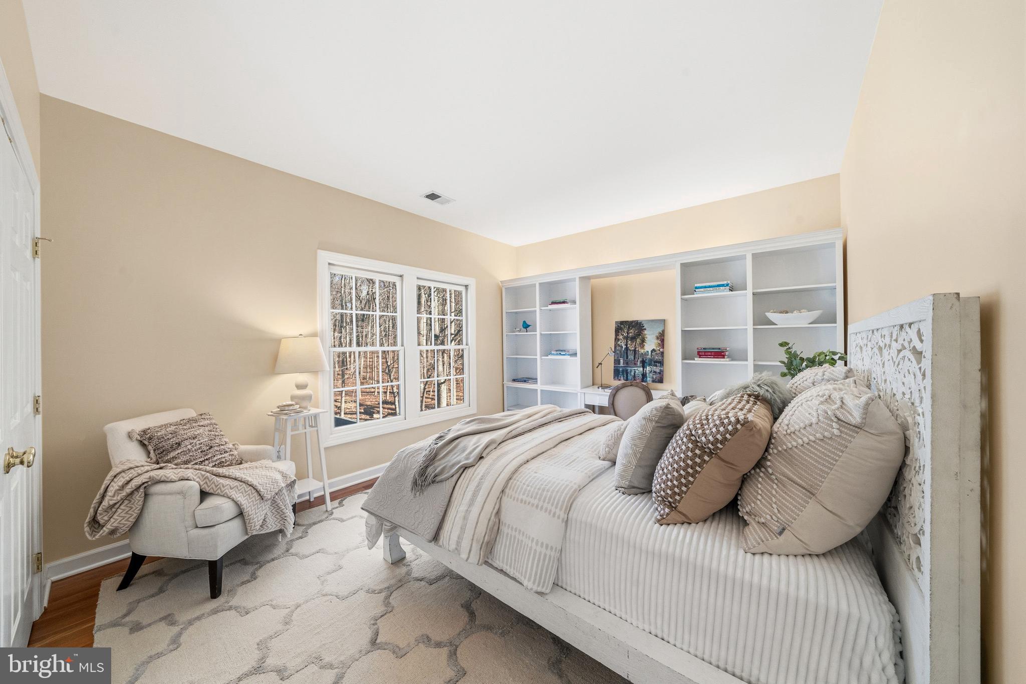 18700 Olney Mill Road Olney, MD 20832 - Photo 57 of 86 a bedroom with a bed and wooden floor