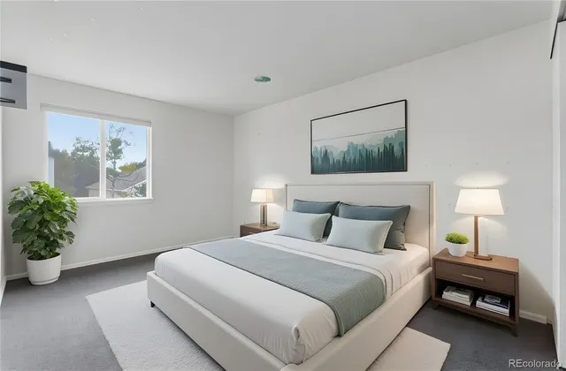 a bedroom with a bed and a potted plant